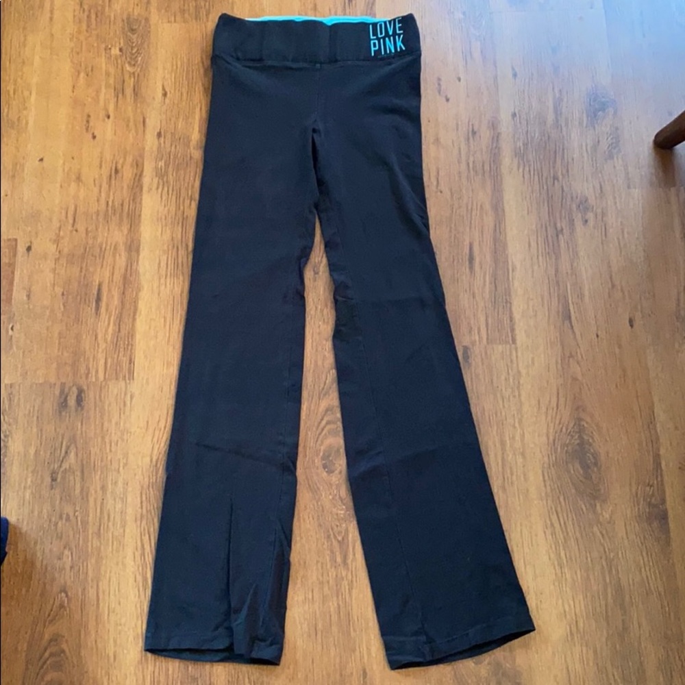 ‘PINK’. Black with light blue yoga pants.
